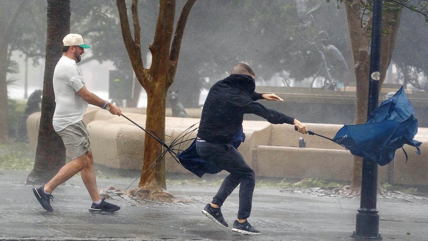Wind gusts, blowing down King Street, twist umbrellas during Hurricane Ian in Charleston, S.C., on Friday, Sept. 30, 2022. (Grace Beahm Alford/The Post and Courier via AP)