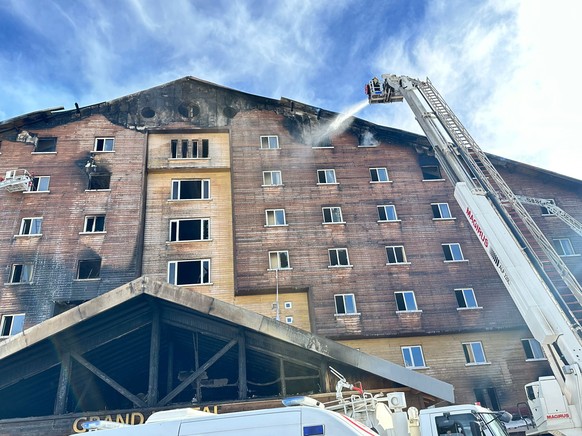 epa11841533 A handout photo made available by Sakarya Municipality Fire Department shows firefighters working at the site of the fire that broke out in a hotel in the Kartalkaya Ski Resort in Bolu, Tu ...