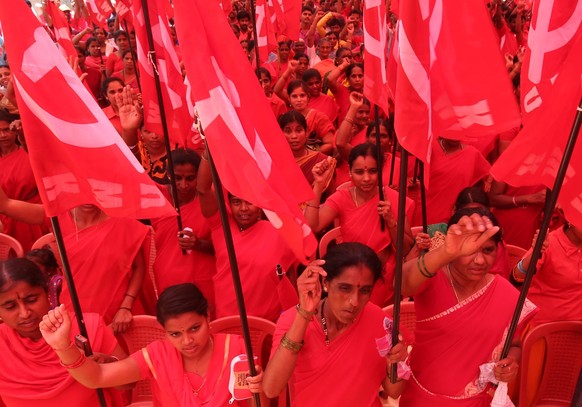 epa05285226 Indian labours and members of different trade unions, hold flags at a rally during International Labour Day in Bangalore, India, 01 May 2016. Labour Day or May Day is observed all over the ...