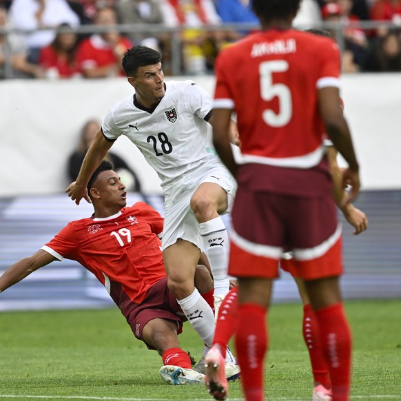 Switzerland&#039;s Dan Ndoye, and Austria&#039;s Flavius David Daniliuc, in action during an international friendly soccer match between Switzerland and Austria at the kybunpark stadium in St. Gallen, ...