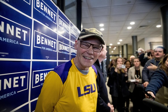 James Carville, a political commentator known for leading former President Bill Clinton's 1992 presidential campaign, smiles as Democratic presidential candidate Sen. Michael Bennet, D-Colo., backgrou ...