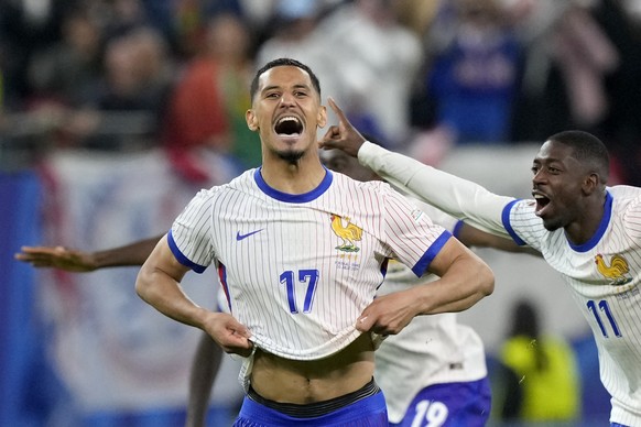 William Saliba of France celebrates after winning a quarter final match between Portugal and France at the Euro 2024 soccer tournament in Hamburg, Germany, Friday, July 5, 2024. France won a penalty s ...