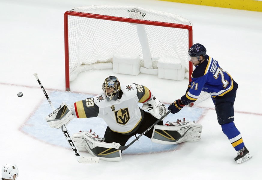 Vegas Golden Knights goaltender Marc-Andre Fleury, left, deflects a puck as St. Louis Blues&#039; Vladimir Sobotka, of the Czech Republic, watches during the third period of an NHL hockey game Thursda ...
