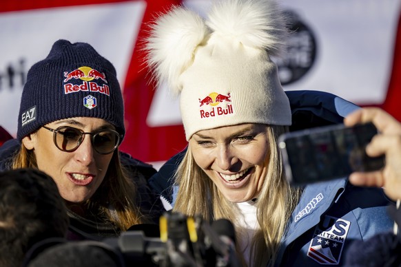 Sofia Goggia of Italy, left, and Lindsey Vonn of United States of America, talk with journalists after completing an alpine ski, women's World Cup super G, in St. Moritz, Switzerland, Saturday, D ...