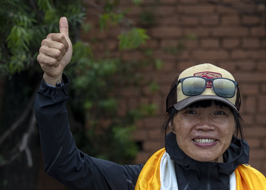 epa09236554 Hong Kong&#039;s climber Tsang Yin-hung gestures upon her arrival from Everest base camp in Kathmandu, Nepal, 30 May 2021. Hong Kong mountaineer Tsang Yin-hung, a former teacher, reportedl ...