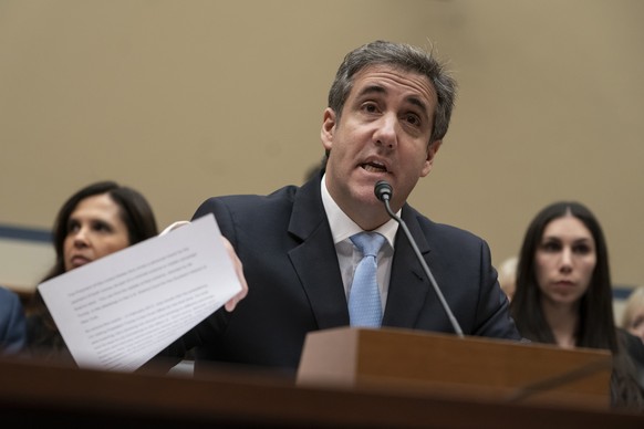 FILE - In this Wednesday, Feb. 27, 2019 file photo, Michael Cohen, President Donald Trump's former personal lawyer, reads an opening statement as he testifies before the House Oversight and Reform Com ...