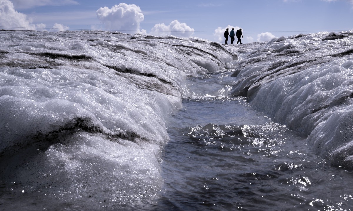 People walk on the Tsanfleuron Glacier at the "Glacier 3000" alpine resort, above Les Diablerets, Switzerland, Saturday, August 6, 2022. The Swiss Glacier Monitoring Switzerland (GLAMOS), fe ...