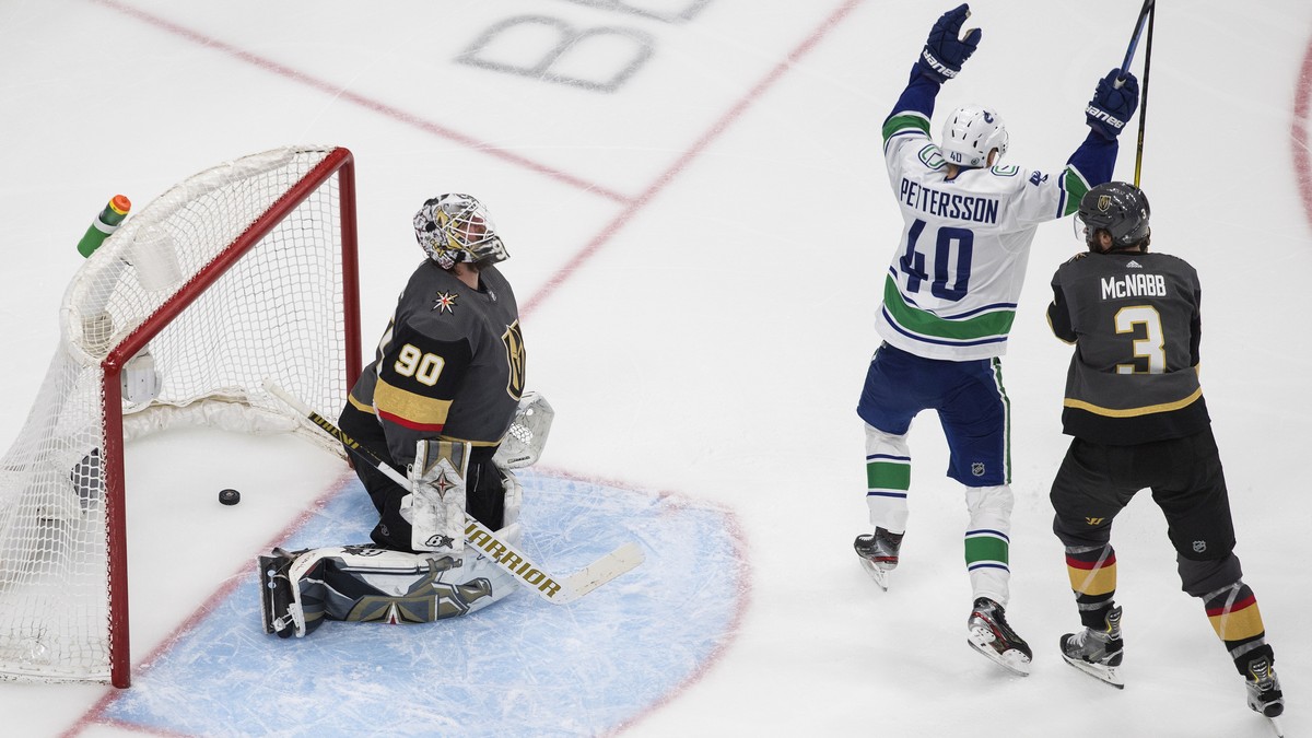 Vancouver Canucks' Elias Pettersson (40) celebrates a goal on Vegas Golden Knights goalie Robin Lehner (90), next to Brayden McNabb (3) during the third period of Game 5 of an NHL hockey second-r ...