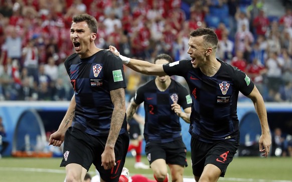 epa06856148 Mario Mandzukic of Croatia reacts with Ivan Perisic of Croatia (R) after scoring the 1-1 the FIFA World Cup 2018 round of 16 soccer match between Croatia and Denmark in Nizhny Novgorod, Ru ...