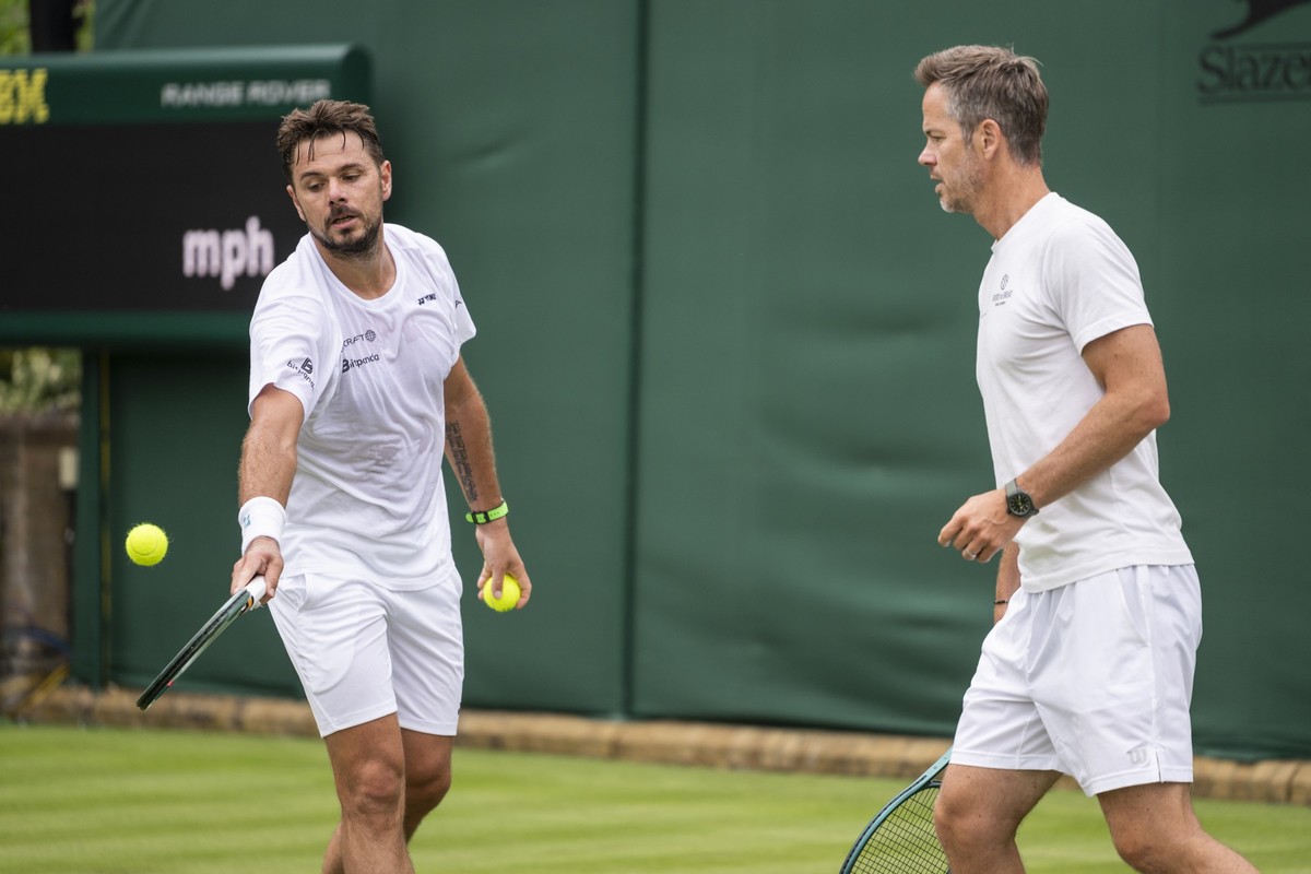 Stanislas Stan Wawrinka of Switzerland, left, with Coach Magnus Norman of Sweden, plays the ball during a practice session, ahead of the All England Lawn Tennis Championships in Wimbledon, London, Fri ...