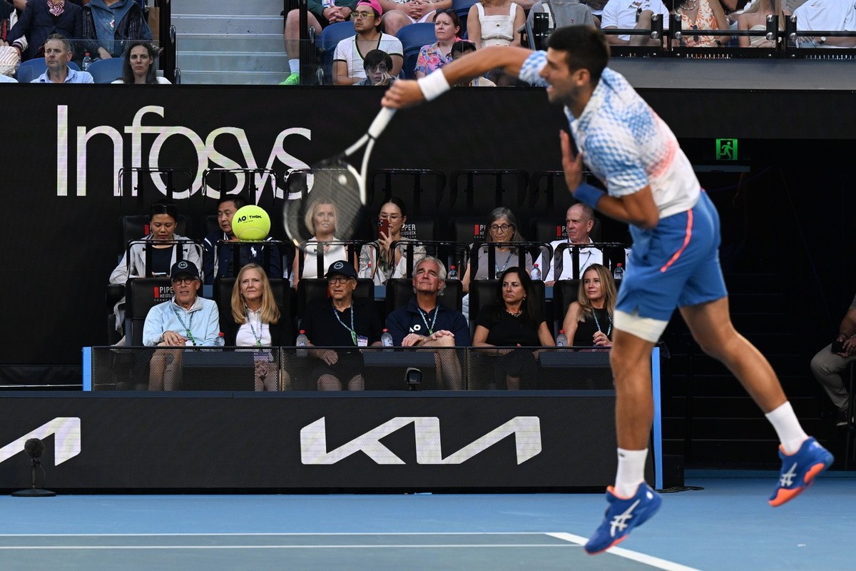 epa10432973 Co-founder of Microsoft Bill Gates (front row, 3-L) watches Novak Djokovic of Serbia serve during the Men's semi final match against Tommy Paul of the United States at the 2023 Austra ...