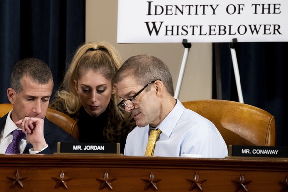 Republican staff attorney Steve Castor, left, and Rep. Jim Jordan, R-Ohio, right, huddle with a staff member as U.S. Ambassador to the European Union Gordon Sondland testifies before the House Intelli ...