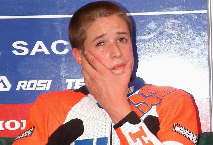 Disappointed Thomas Luethi of Switzerland takes a rest after the 125 cc class qualification for the Czech Motorcycling Grand Prix on Masaryk circuit in Brno, Saturday, August 24, 2002. The 15-year-old ...