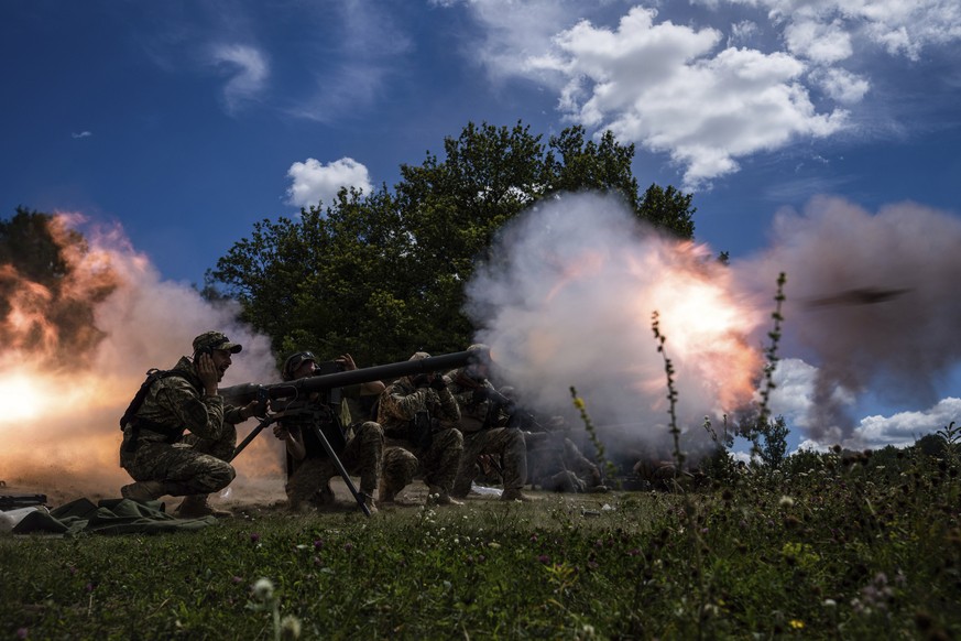 FILE - Ukrainian servicemen shoot with a SPG-9 recoilless gun during training in Kharkiv region, Ukraine, July 19, 2022. Six months ago, Russian President Vladimir Putin sent troops into Ukraine in an ...