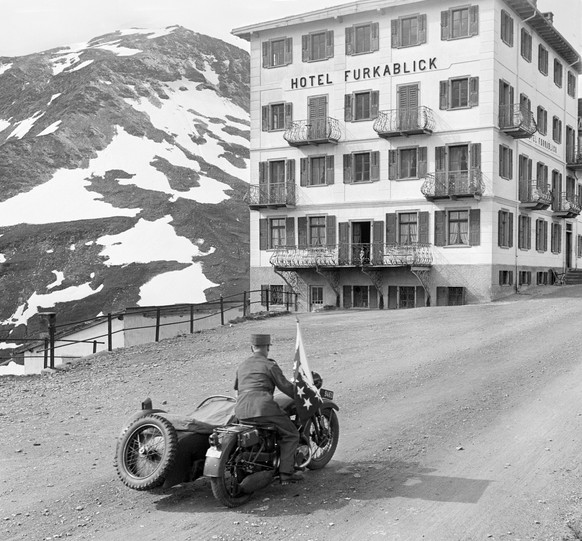 A motorcyclist transports a torch, which was ignited on the Ruetli meadow in the morning, over the Furka Pass. Torchbearers carry the fire for the Swiss 650 year anniversary to all parts of the countr ...