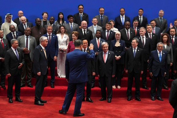Chinese President Xi Jinping, center waves to other attendees after a group photo before the opening ceremony for the World AI Conference in Shanghai, Friday, July 17, 2026. (AP Photo/Ng Han Guan, Poo ...