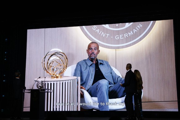epa12398680 Paris Saint-Germain head coach Luis Enrique appears on screen as he receives the mens Johan Cruyff Trophy for Coach of the Year during the Ballon d&#039;Or 2025 ceremony at the Theatre du ...