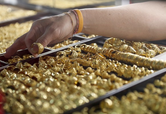 epa12667151 A goldsmith displays gold ornaments during gold trade at Hua Seng Heng gold shop in Bangkok, Thailand, 21 January 2026. Thailand's gold prices continue to surge, following global tren ...