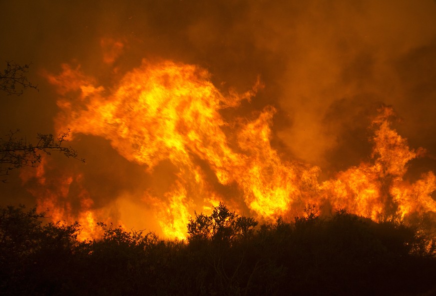 Flames from a wildfire burn Monday, Oct. 9, 2017, in Napa, Calif. The fire is one of several burning across Northern California&#039;s wine country. (AP Photo/Rich Pedroncelli)