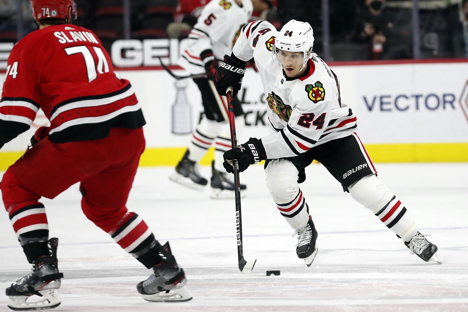 Chicago Blackhawks&#039; Pius Suter (24) works the puck against Carolina Hurricanes&#039; Jaccob Slavin (74) during the first period of an NHL hockey game in Raleigh, N.C., Tuesday, May 4, 2021. (AP P ...