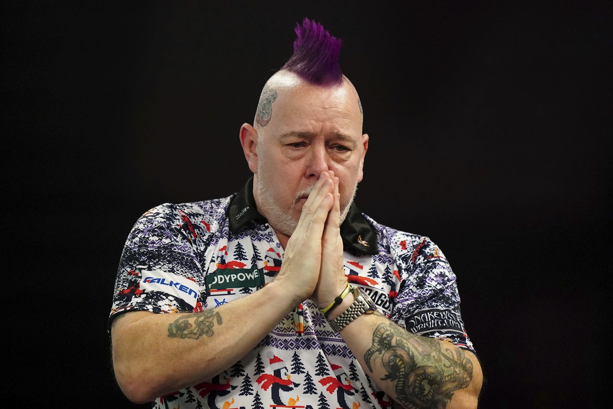 Peter Wright reacts after winning his fourth round match against Luke Humphries on day twelve of the World Darts Championship at Alexandra Palace, in London, Sunday, Dec. 29, 2024. (Zac Goodwin/PA via ...