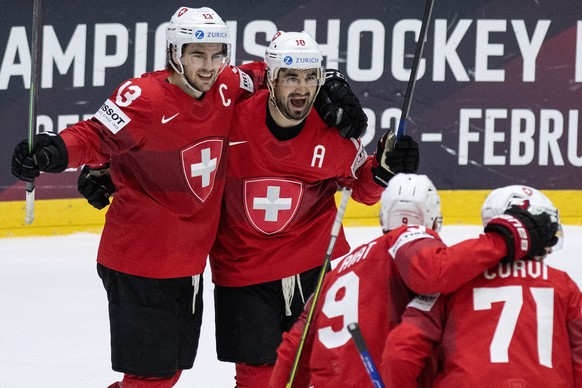 epa09967313 Switzerland&#039;s Nico Hischier (L) and Andres Ambuehl celebrate the goal to 3-2 during the IIHF Ice Hockey World Championship group A preliminary round match between Switzerland and Fran ...