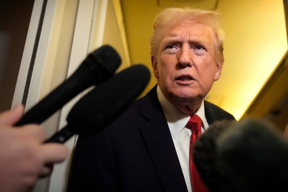 President Donald Trump speaks to reporters aboard Air Force One, Sunday, Oct. 19, 2025, en route to Joint Base Andrews, Md., as he returns from a trip to Florida. (AP Photo/Mark Schiefelbein)
Donald T ...