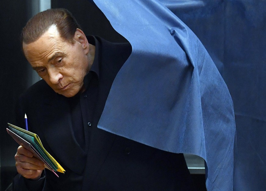 Italian former prime minister and leader of &#039;Forza Italia&#039; party Silvio Berlusconi votes in a polling station in Milan, Sunday, March 4, 2018. Sunday&#039;s vote is one being watched to see  ...