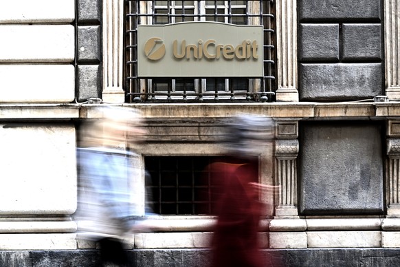 epa11743851 People walk past a sign with the logo of the Italian bank UniCredit on its bank branch in central Genova, Italy, 27 November 2024. Italy&#039;s second biggest bank UniCredit on 25 November ...