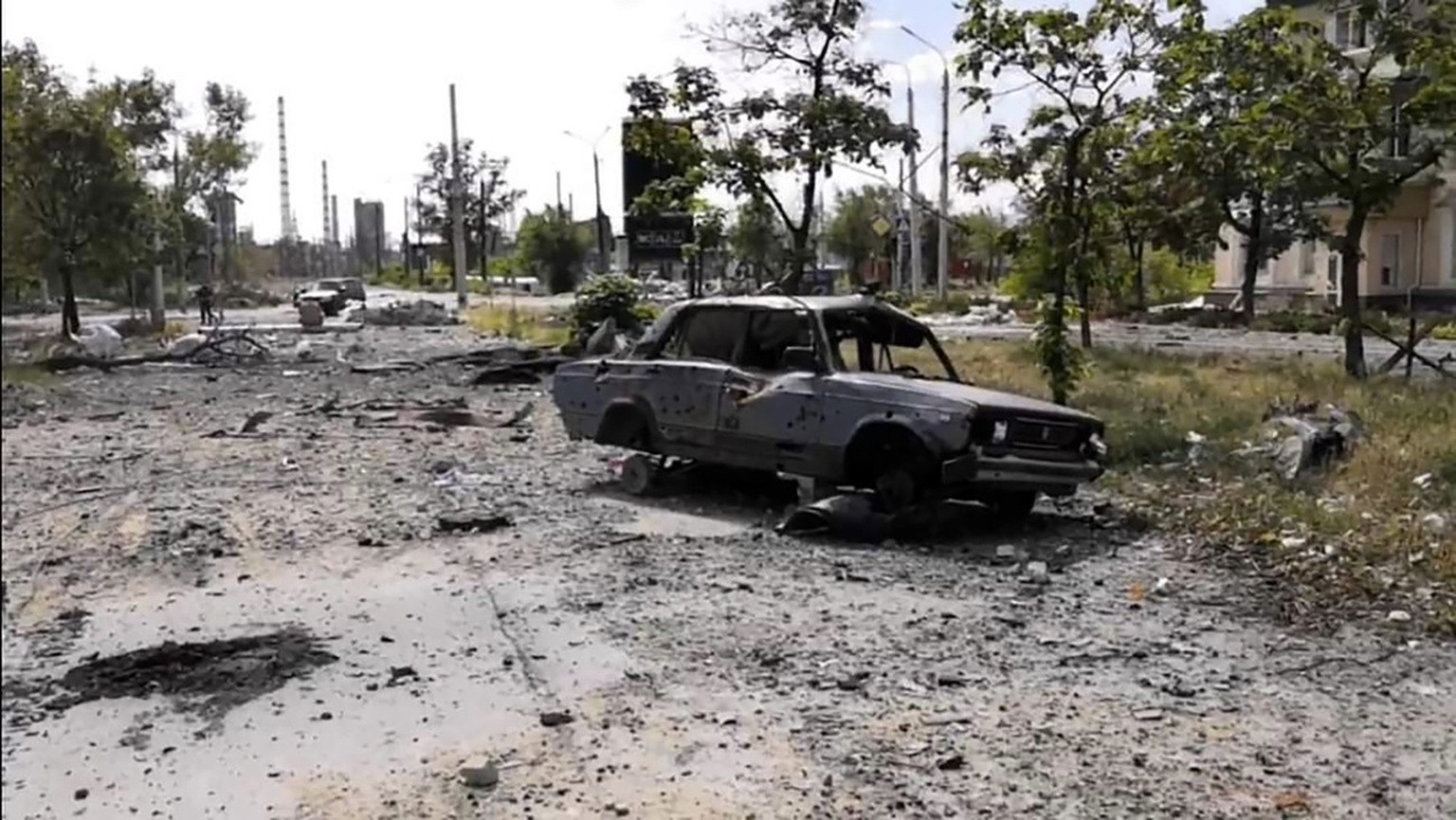 In this photo provided by the Luhansk region military administration, burned car and damaged residential buildings are seen in Lysychansk, Luhansk region, Ukraine, early Sunday, July 3, 2022. Russian  ...