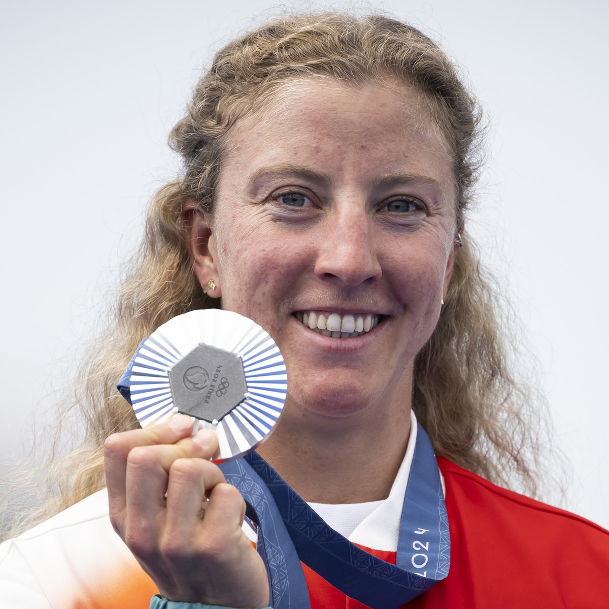Silver medallist Julie Derron of Switzerland celebrates on the podium during the medal ceremony for the women's triathlon competition at the 2024 Paris Summer Olympics in Paris, France, Wednesday ...