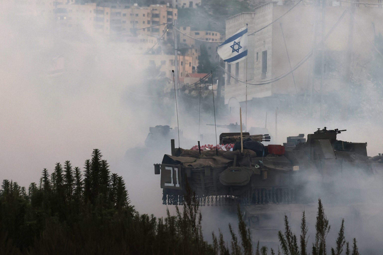 epa11919301 Israeli forces with tanks enter Jenin refugee camp in the West Bank city of Jenin, 23 February 2025. The Israeli military launched a military operation in Jenin and its camp on 21 January, ...