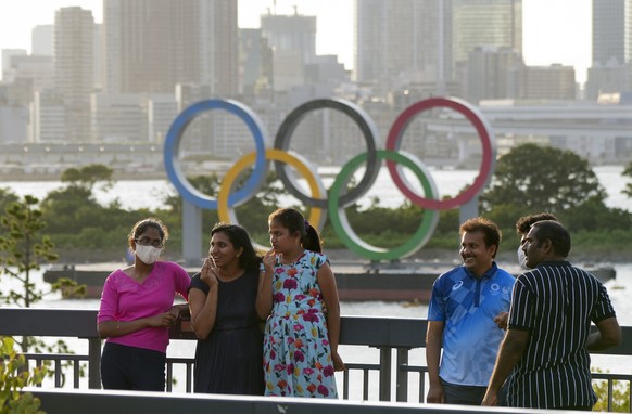 epa09358072 Indian resident in Japan visit Odaiba Marine Park to see the Olympic Ring Monument at Odaiba, a day before the Tokyo 2020 Olympic Games Opening Ceremony in Tokyo, Japan, 22 July 2021. The  ...