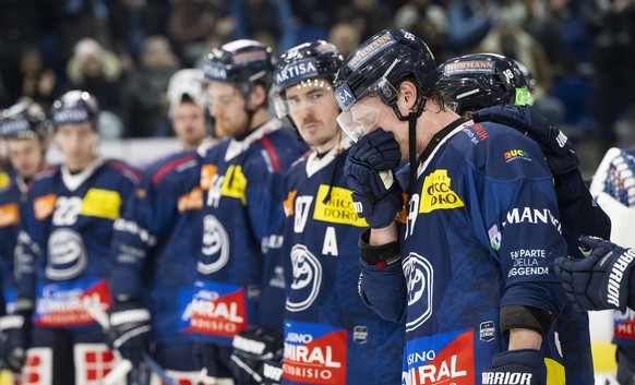 Ambri&#039;s Dario Wuethrich is comforted by his teammates after the National League regular season game between the HC Ambri Piotta and the SCL Tigers at the ice stadium Gottardo Arena, Switzerland,  ...