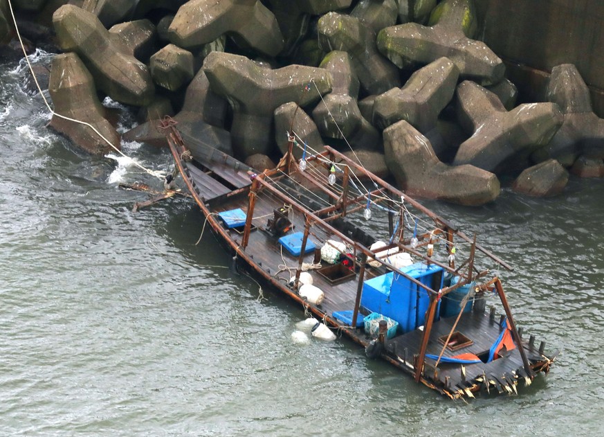 A wooden boat is moored at a nearby marina, in Yurihonjo, Akita prefecture, northern Japan, Friday, Nov. 24, 2017. Japanese police are investigating eight men found on Japan&#039;s northern coast who  ...