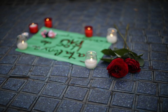Flowers and candles are placed on the pavement on a street in Las Ramblas, Barcelona, Spain, Friday, Aug. 18, 2017. Spanish police on Friday shot and killed five people carrying bomb belts who were connected to the Barcelona van attack that killed at least 13, as the manhunt intensified for the perpetrators of Europe's latest rampage claimed by the Islamic State group. (AP Photo/Manu Fernandez)