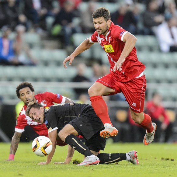 Rubin&#039;s Maksim Kanunnikov, left, challenges for the ball with Sion&#039;s Veroljub Salatic, right, during the UEFA Europa League group B soccer match between FC Sion and FC Rubin Kazan at the Tou ...