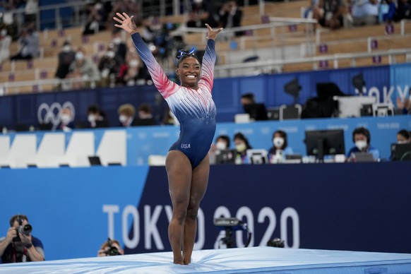 Simone Biles, of the United States, finishes on the balance beam during the artistic gymnastics women&#039;s apparatus final at the 2020 Summer Olympics, Tuesday, Aug. 3, 2021, in Tokyo, Japan. (AP Ph ...