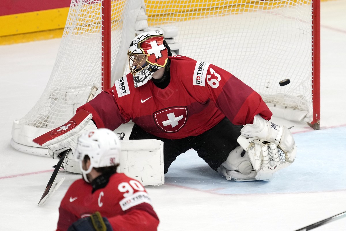 Switzerland's goalkeeper Leonardo Genoni is scored on by Czech Republic's David Pastrnak as Switzerland's Roman Josi watches during the gold medal match between Czech Republic and Switz ...