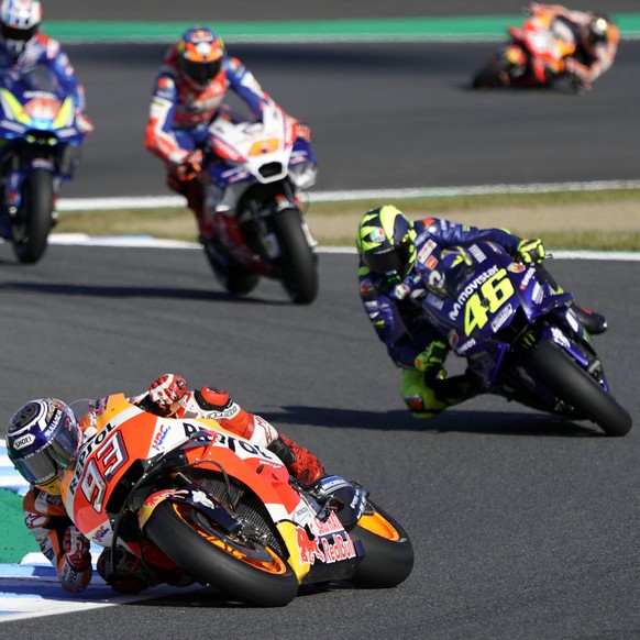 Spain&#039;s rider Marc Marquez (93) steers his Honda tailed by Italy&#039;s Valentino Rossi of Yamaha during the MotoGP Japanese Motorcycle Grand Prix at the Twin Ring Motegi circuit in Motegi, north ...
