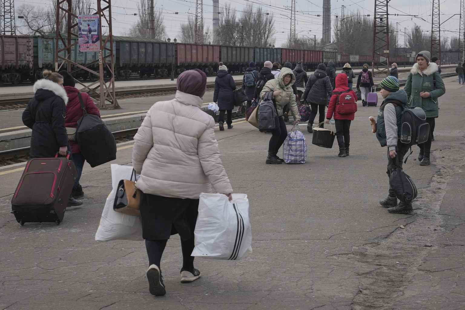 People waiting for a Kiev bound train spread on a platform in Kostiantynivka, the Donetsk region, eastern Ukraine, Thursday, Feb. 24, 2022. Russia launched a wide-ranging attack on Ukraine on Thursday ...
