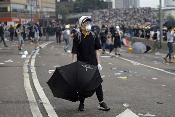 epa07643776 Protesters react during a rally against an extradition bill outside the Legislative Council in Hong Kong, China, 12 June 2019. The bill, scheduled for a second reading on 12 June has faced ...