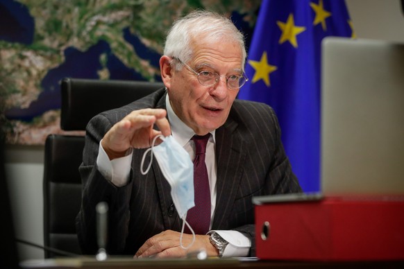 epa08889407 High Representative of the European Union for Foreign Affairs and Security Policy Josep Borrell, holds a face mask during an interview with EFE, via videoconference in Brussels, Belgium, 1 ...