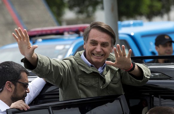 Jair Bolsonaro, presidential candidate with the Social Liberal Party, waves after voting in the presidential runoff election in Rio de Janeiro, Brazil, Sunday, Oct. 28, 2018. Bolsonaro is running agai ...
