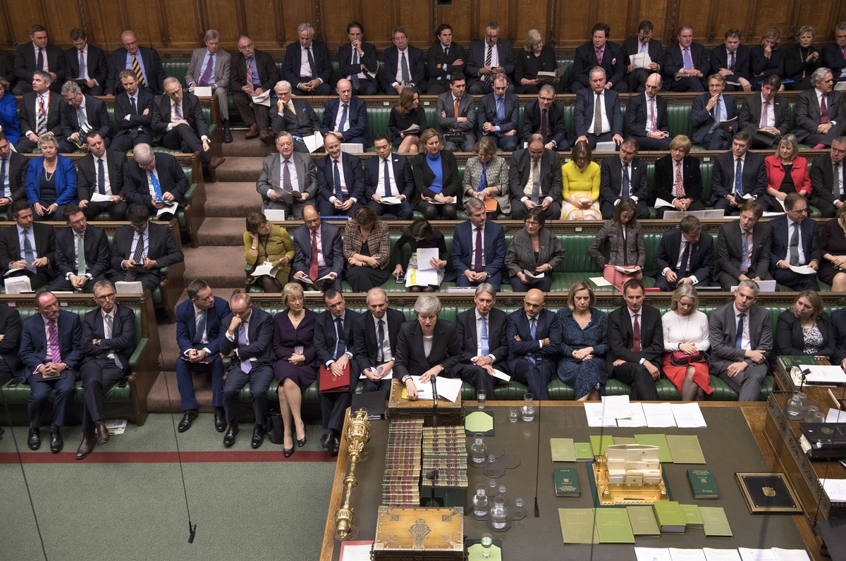 Britain's Prime Minister Theresa May, standing centre foreground, makes a reply to lawmakers during the scheduled Prime Minister's Questions time, in the House of Commons, London, Wednesday  ...