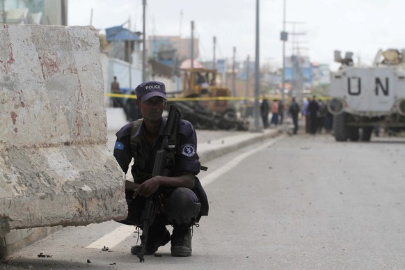 A Somalia policeman watches the scene of a suicide bombing near the African Union's main peacekeeping base in Mogadishu, Somalia, July 26, 2016. REUTERS/Ismail Taxta