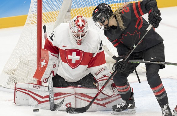 Canada forward Natalie Spooner (24) is stopped by Switzerland goalkeeper Andrea Braendli (20) during the first period of a women&#039;s hockey game Thursday, Feb. 3, 2022, at the Winter Olympics in Be ...