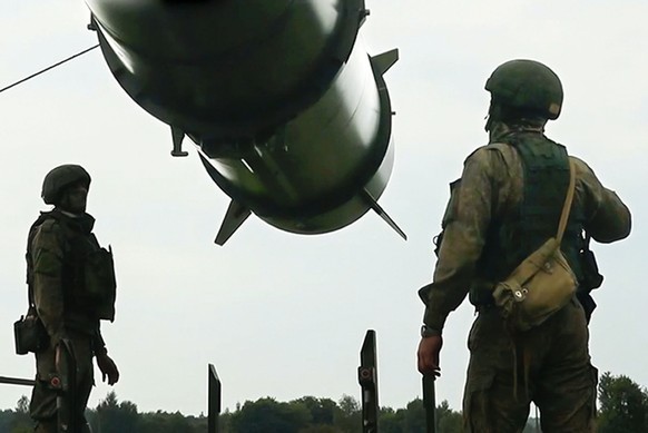 FILE - In this photo taken from video released by the Russian Defense Ministry Press Service on Wednesday, June 12, 2024, Russian soldiers load a Iskander-M short-range ballistic missile launchers at  ...