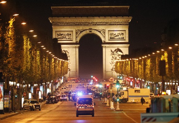 Police forces take positions on the Champs Elysees avenue in Paris, France, after a fatal shooting in which a police officer was killed along with an attacker, Thursday, April 20, 2017. An attacker wi ...
