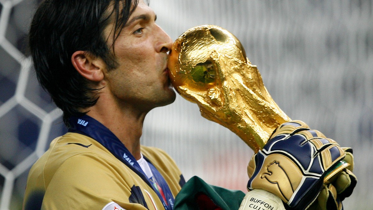 Italy's goal keeper Gianluigi Buffon kisses the World Cup trophy after the final of the soccer World Cup between Italy and France in the Olympic Stadium in Berlin, Sunday, July 9, 2006. Italy bea ...